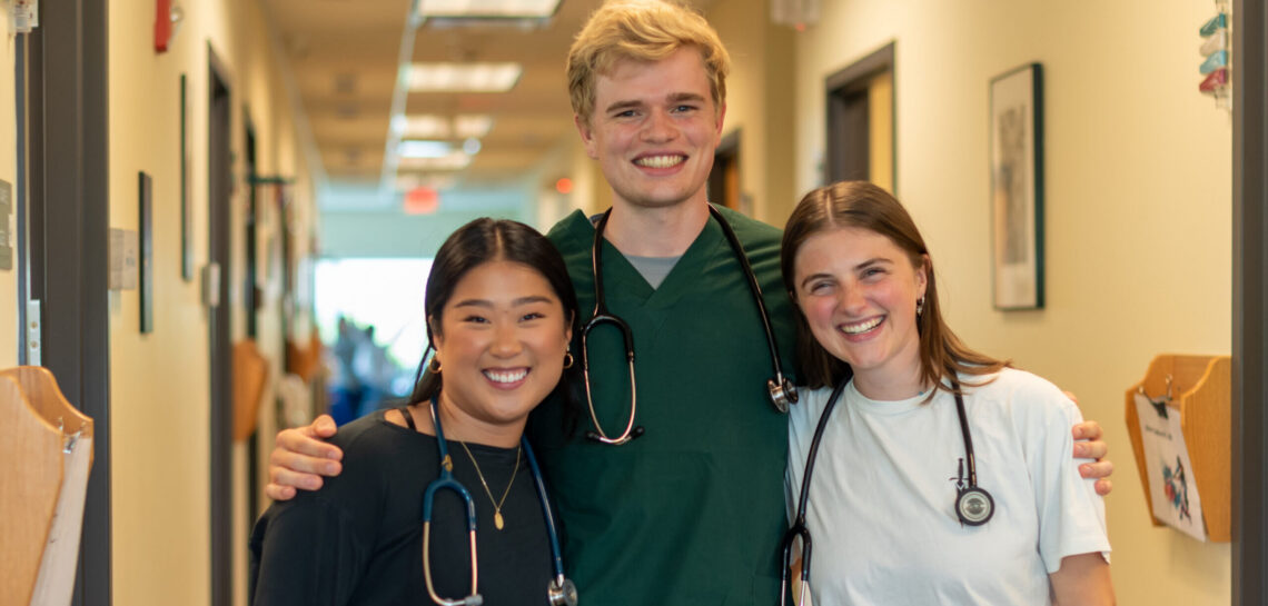 clinicians smile while having their photo taken at a CHC clinic